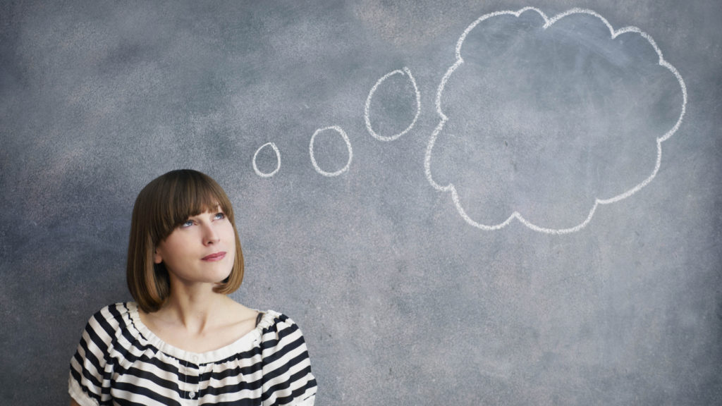 woman with thought bubble on chalk board